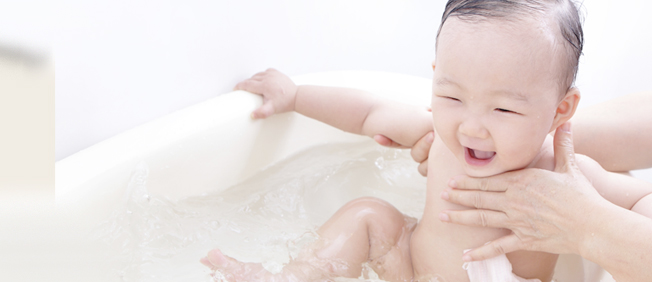 Baby laughing in bathtub